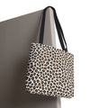 Leopard print tote bag with black straps on a neutral background