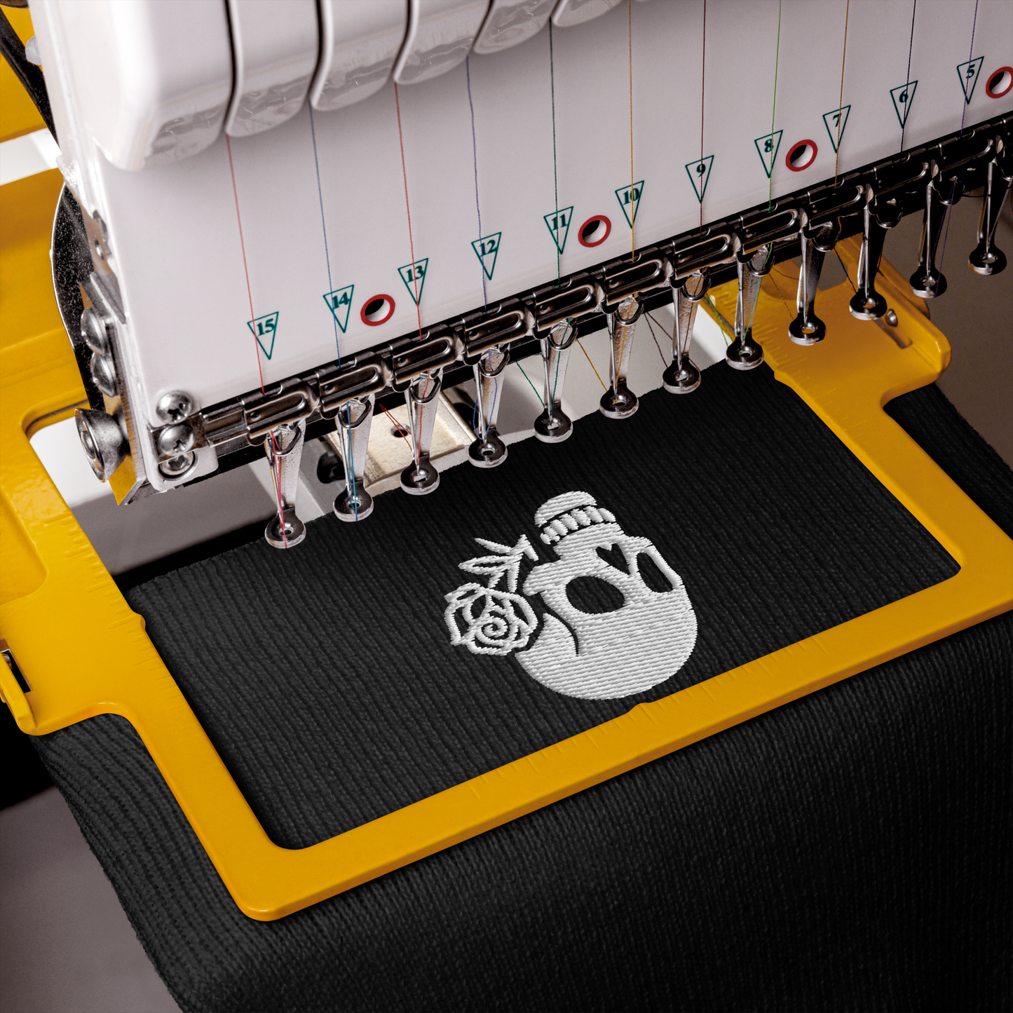 Embroidery machine with skull design on a black fabric