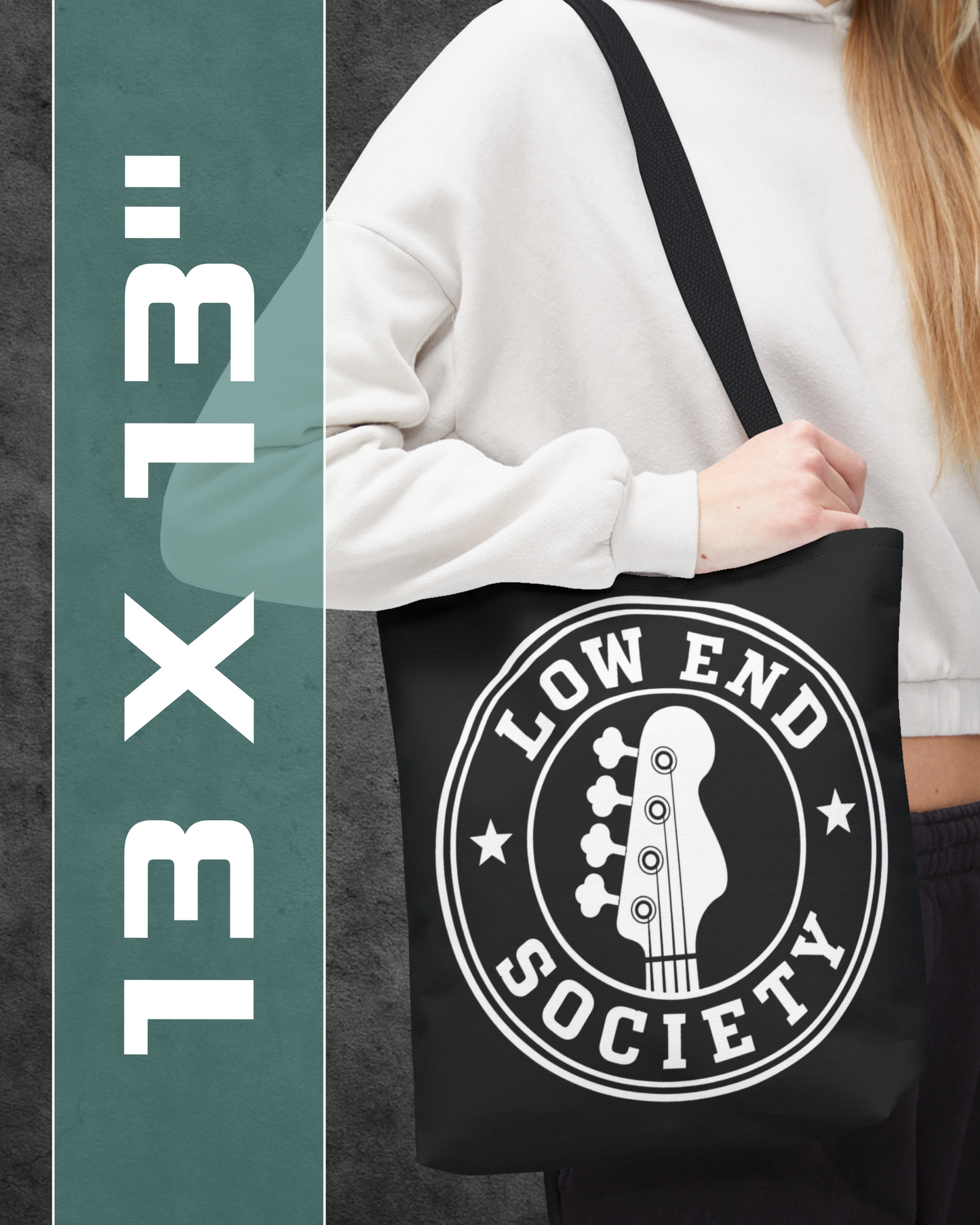 Person holding a black tote bag with 'Low End Society' logo, with text '13 x 13' on the side.