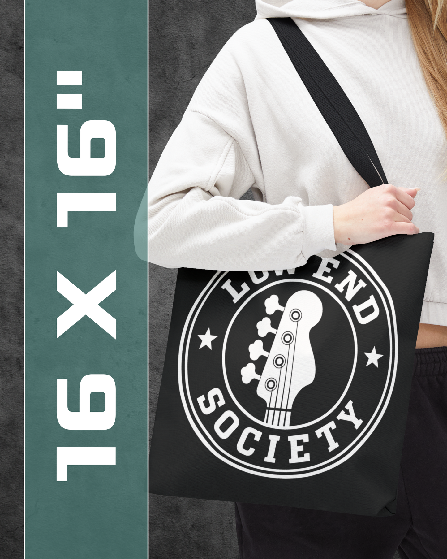 Person holding a black tote bag with 'Legend Society' logo, 16x16 inch size text on the side.