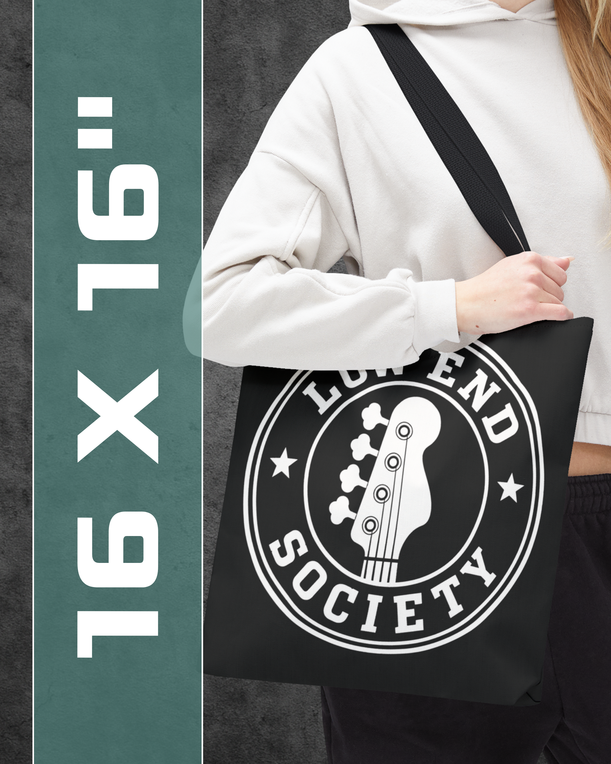 Person holding a black tote bag with 'Legend Society' logo, 16x16 inch size text on the side.