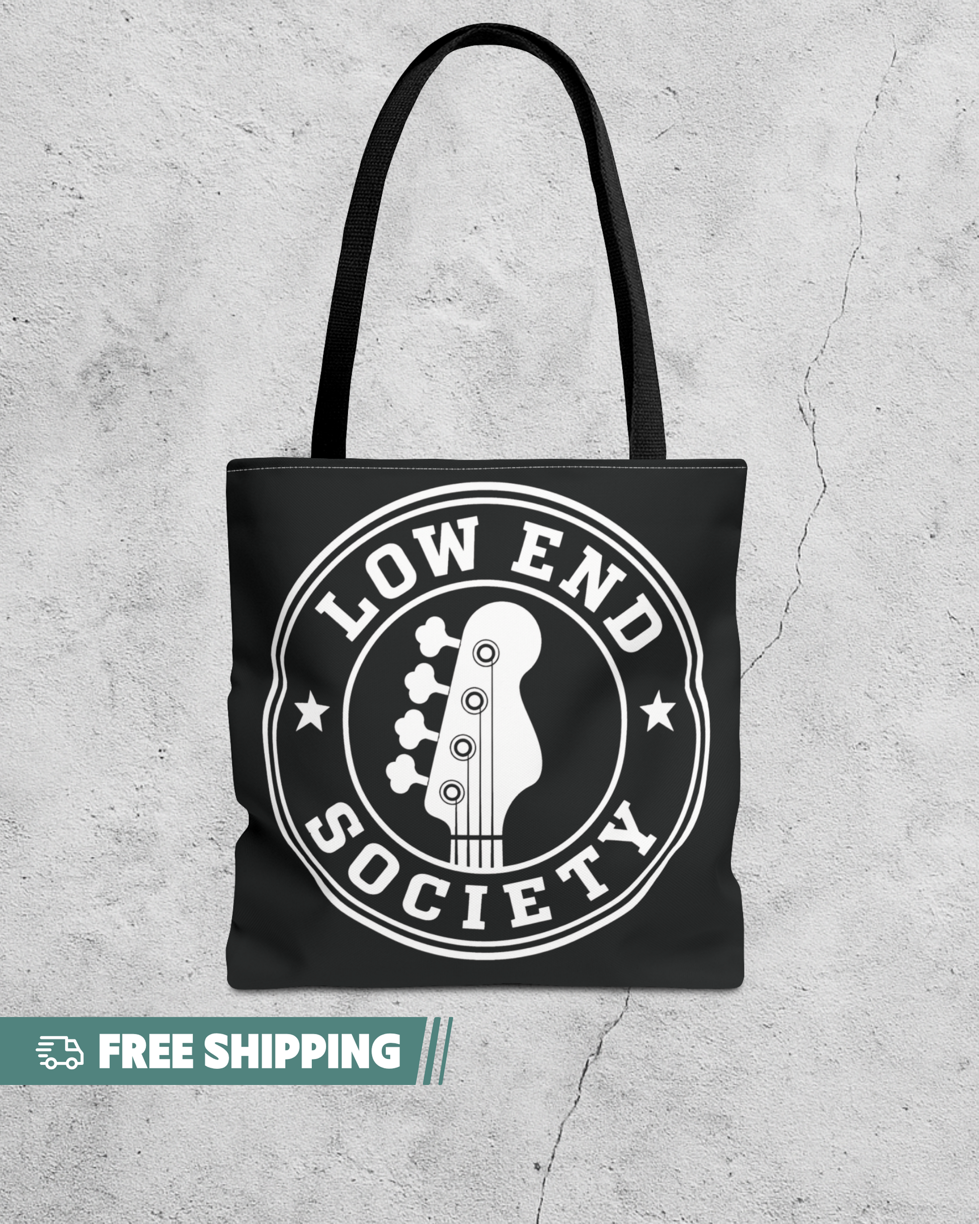 Black tote bag with 'Low End Society' logo on a textured gray background