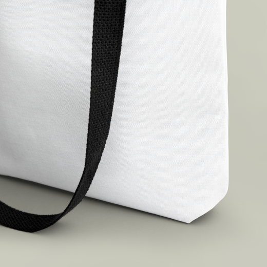White bag with a black strap on a light gray background